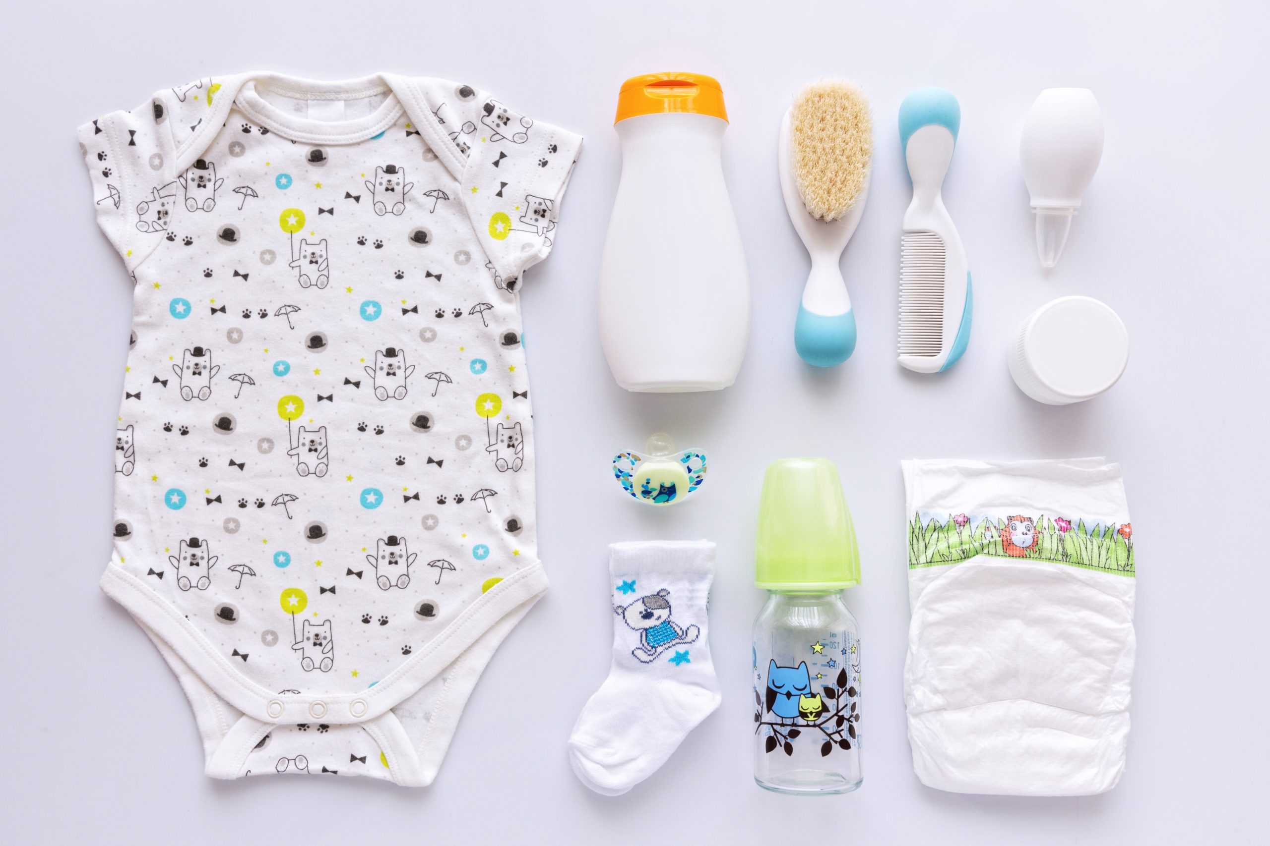 Display of items to prepare for a newborn baby. Onesie, bottle, other essentials
