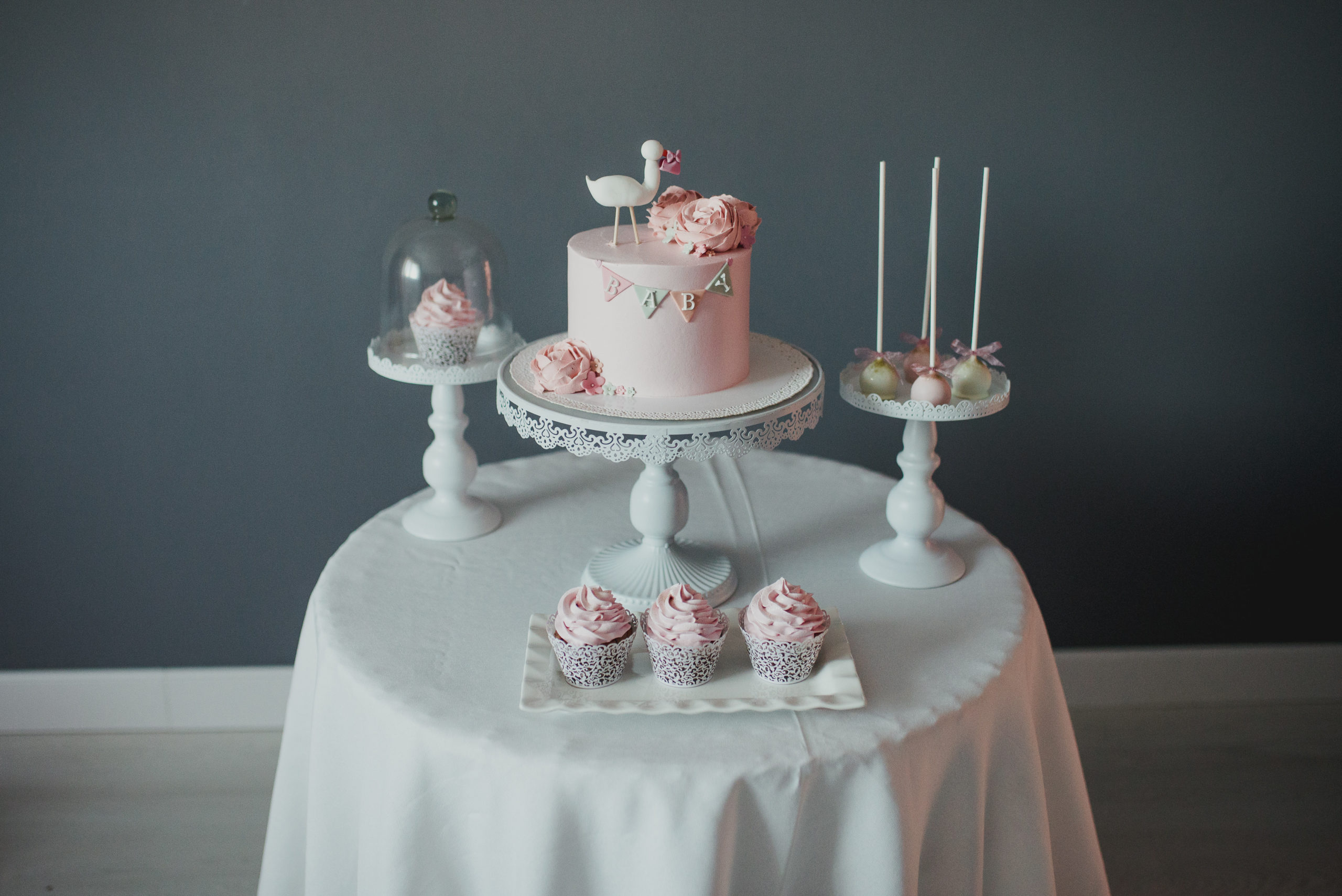 Table of baby shower cakes, cupcakes, and other baby shower dessert ideas.
