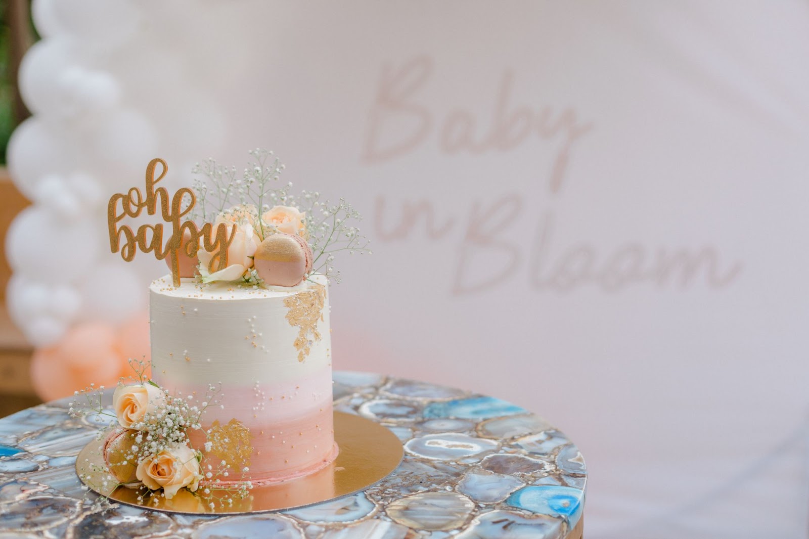 Baby Shower Cake with flowers on a table.